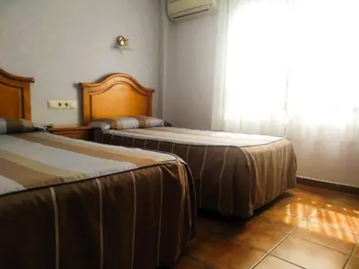 Cama o camas de una habitación en Hostal la Cepa