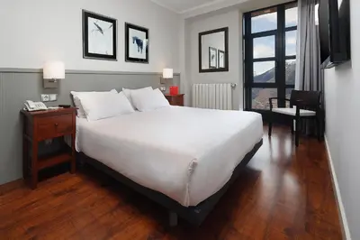 Cama o camas de una habitación en Apartamentos HG Cerler