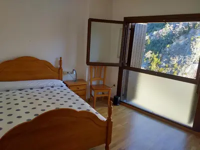 Cama o camas de una habitación en TU APARTAMENTO EN FORMIGAL-PANTICOSA SALLENT-Escarrilla