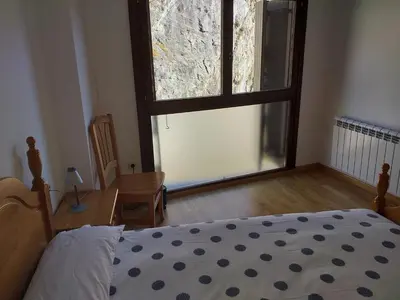 Cama o camas de una habitación en TU APARTAMENTO EN FORMIGAL-PANTICOSA SALLENT-Escarrilla