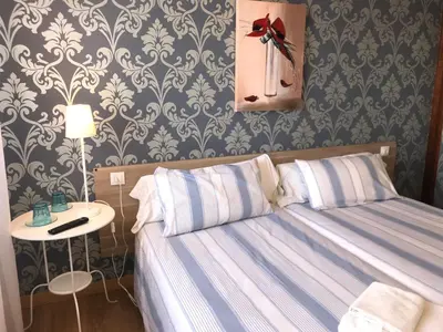 Cama o camas de una habitación en Alojamientos Iruña