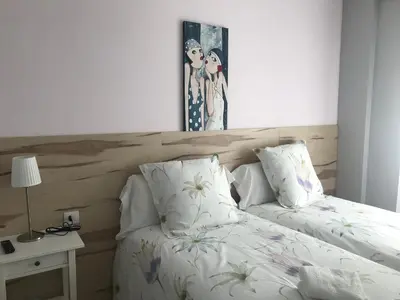 Cama o camas de una habitación en Alojamientos Iruña