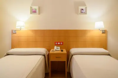 Cama o camas de una habitación en Hotel Villa de Zaragoza