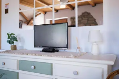 Una televisión o centro de entretenimiento en Casa Maza Apartamentos