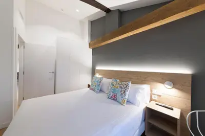 Cama o camas de una habitación en Antique Pamplona Tres Reyes Apartments