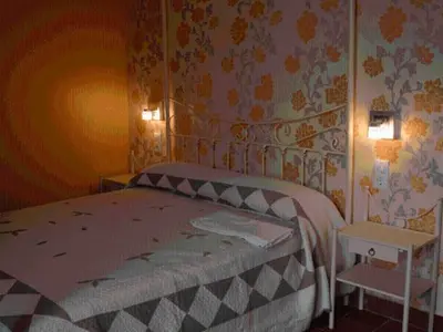 Cama o camas de una habitación en Hostal La Fuente