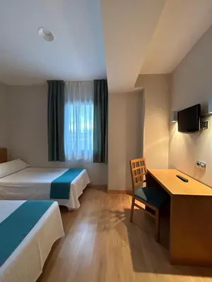 Cama o camas de una habitación en Hostal Aralar