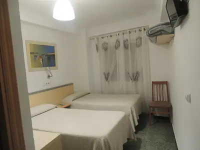 Cama o camas de una habitación en Hostal Cumbre