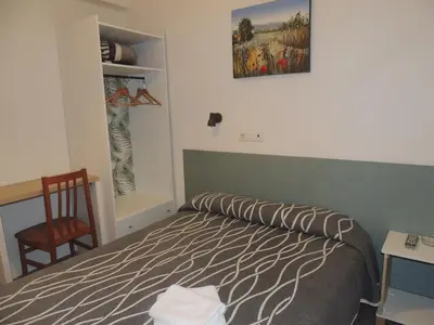 Cama o camas de una habitación en Hostal Cumbre