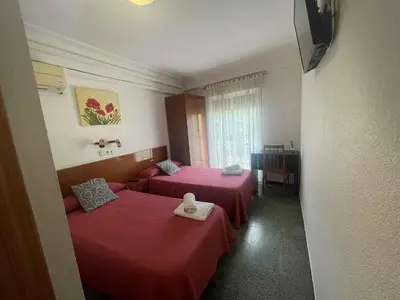 Cama o camas de una habitación en Hostal Cumbre