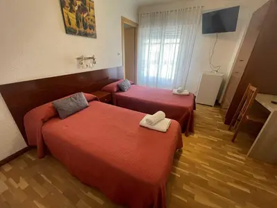 Cama o camas de una habitación en Hostal Cumbre