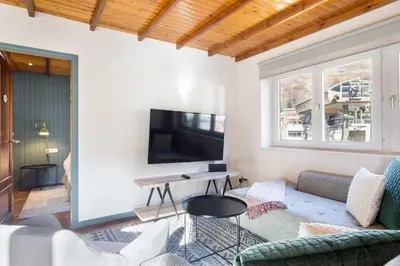 Una televisión o centro de entretenimiento en Luderna - Apartamento Cap de Aran A3