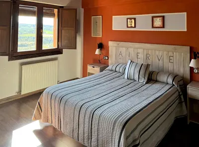 Cama o camas de una habitación en Hotel rural reina Berta