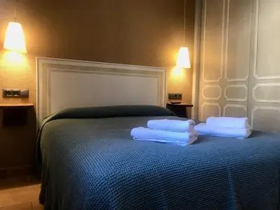Cama o camas de una habitación en Apartamentos Blasco