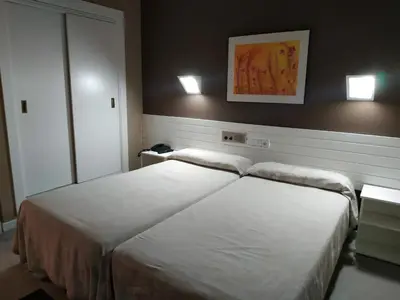 Cama o camas de una habitación en Hotel Fidalgo