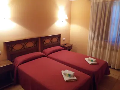 Cama o camas de una habitación en Hospedería Prepirineo