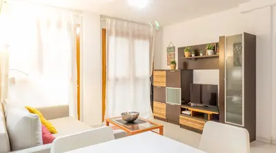 Una televisión o centro de entretenimiento en Apartamentos La Rosa I Acogedor Apto a 2 Min del Pilar