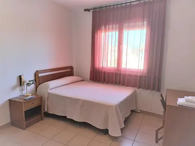 Cama o camas de una habitación en Hostal Fontdemora