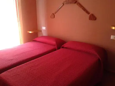 Cama o camas de una habitación en Apartamentos Turísticos Las Saladas