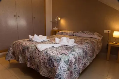Cama o camas de una habitación en Ático con terraza en Graus-Pirineo de Huesca