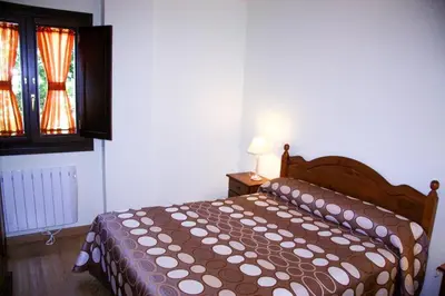 Cama o camas de una habitación en Apartamentos La Catedral