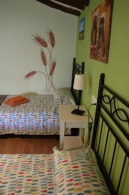 Cama o camas de una habitación en Casa rural tres regiones