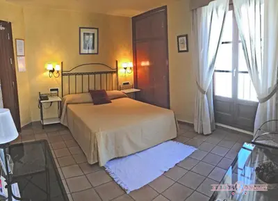 Cama o camas de una habitación en HOTEL GUADALOPE