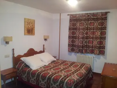 Cama o camas de una habitación en Apartamentos Petronilla