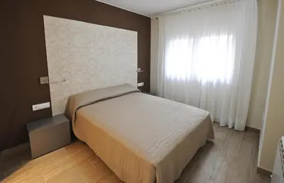 Cama o camas de una habitación en Apartamentos Turísticos Mirablanc