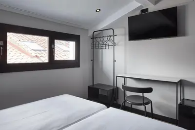 Cama o camas de una habitación en Hostal Espoz y Mina