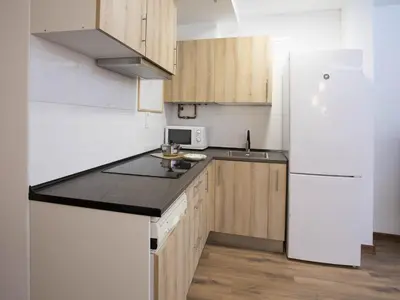 Una cocina o zona de cocina en Apartamentos El Pilar