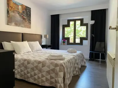 Cama o camas de una habitación en LC Apartamentos César Augusto