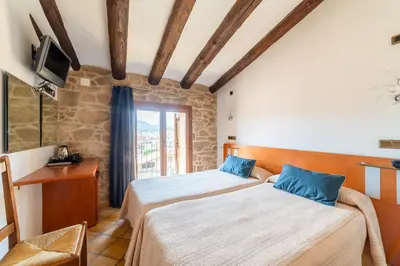 Cama o camas de una habitación en HOTEL EL CASTELL