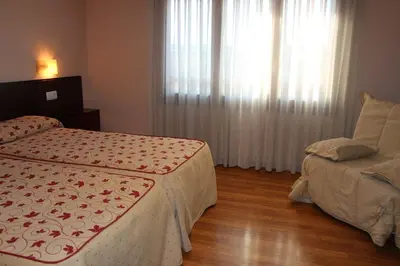Cama o camas de una habitación en Aparthotel Tres Caminos