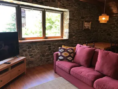 Una televisión o centro de entretenimiento en Arties Centro 2 habitaciones, exclusivo familias