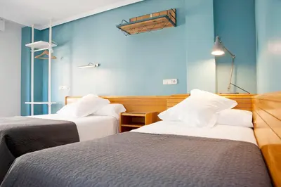 Cama o camas de una habitación en Apartamentos Sabinas Don Jaime