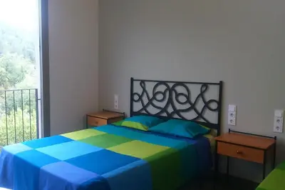 Cama o camas de una habitación en CASA SAPEIRÓ - Allotjament Rural