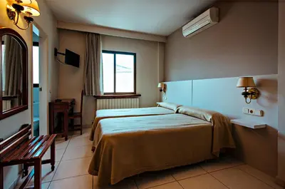 Cama o camas de una habitación en Hotel BONCOMPTE