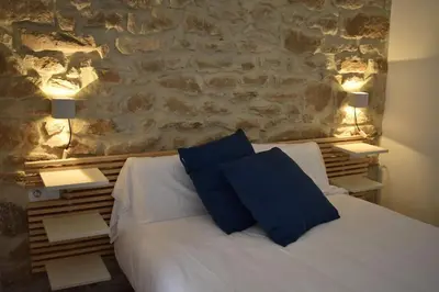 Cama o camas de una habitación en La casa de la raval de l’Albagés