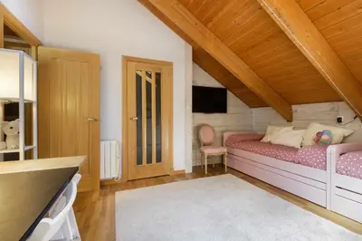 Cama o camas de una habitación en Fuente del Tesoro, dúplex vacacional en Panticosa