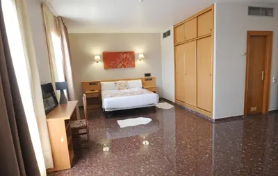 Cama o camas de una habitación en HOTEL MARIA ROSA