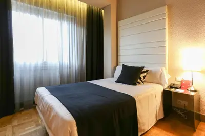 Cama o camas de una habitación en Habitus Hotel Leyre