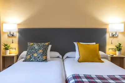 Cama o camas de una habitación en Hotel Monasterio Benedictino