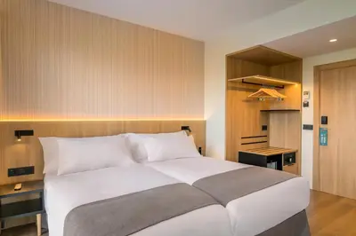 Cama o camas de una habitación en Occidental Pamplona