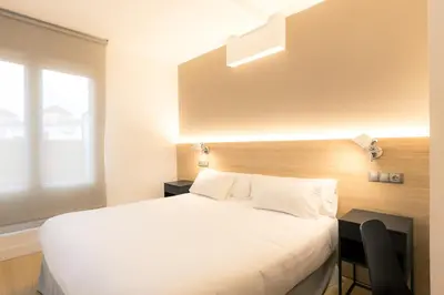 Cama o camas de una habitación en Hotel Burlada