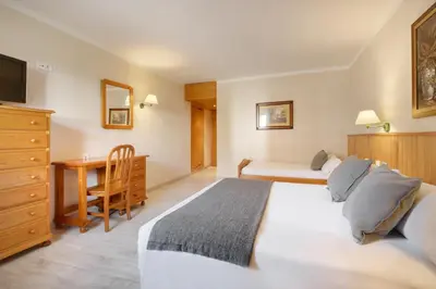 Cama o camas de una habitación en Hotel Nievesol