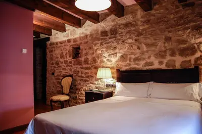 Cama o camas de una habitación en Hotel Rural Nobles de Navarra