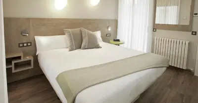 Cama o camas de una habitación en Hotel Dos Rios Central