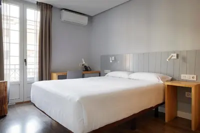 Cama o camas de una habitación en Hotel Avenida