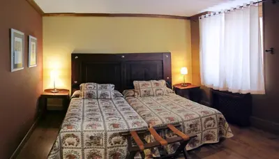 Cama o camas de una habitación en Hotel Hospital de Benasque